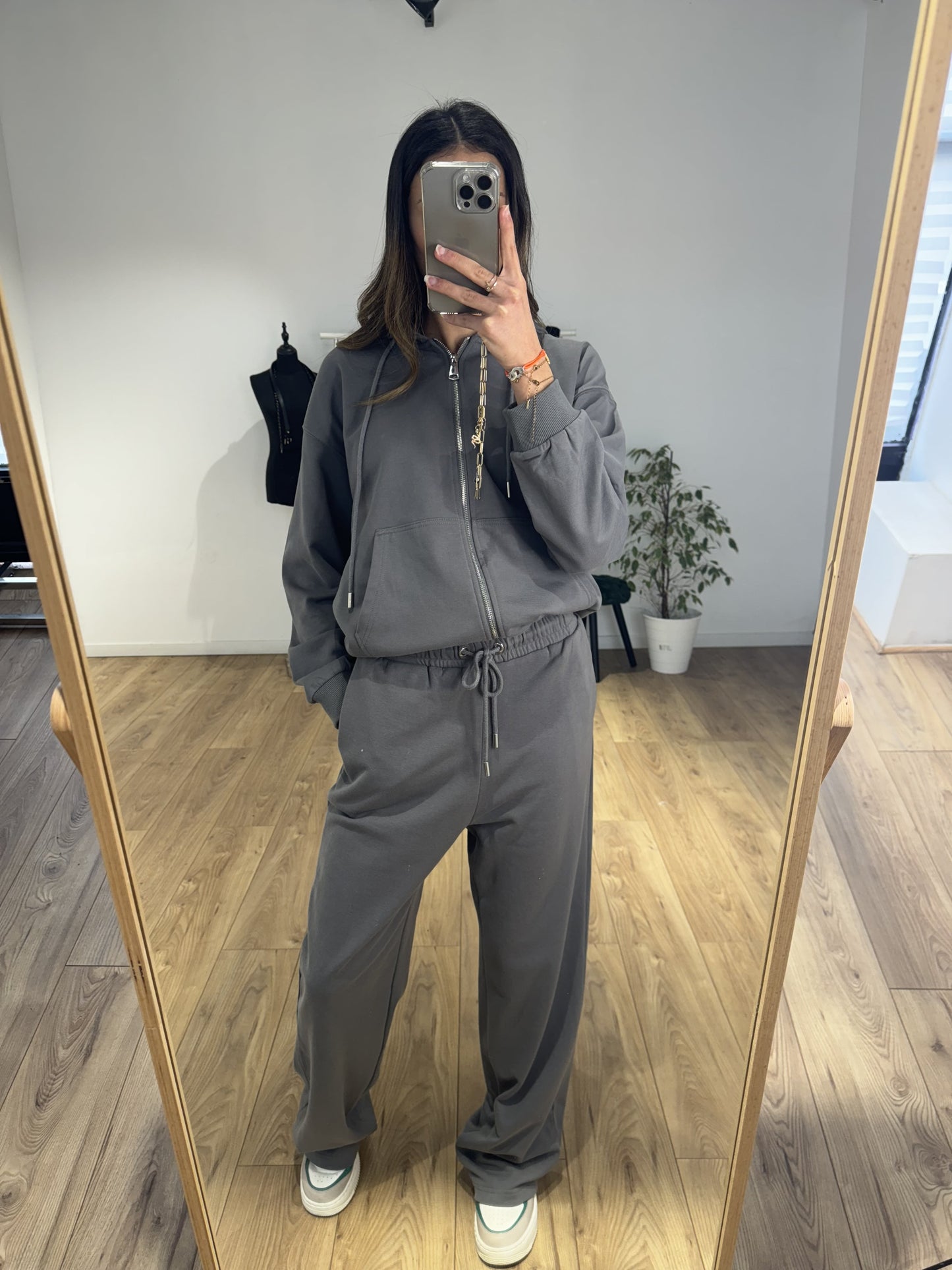 Femme portant un pantalon en coton gris avec un hoodie assorti